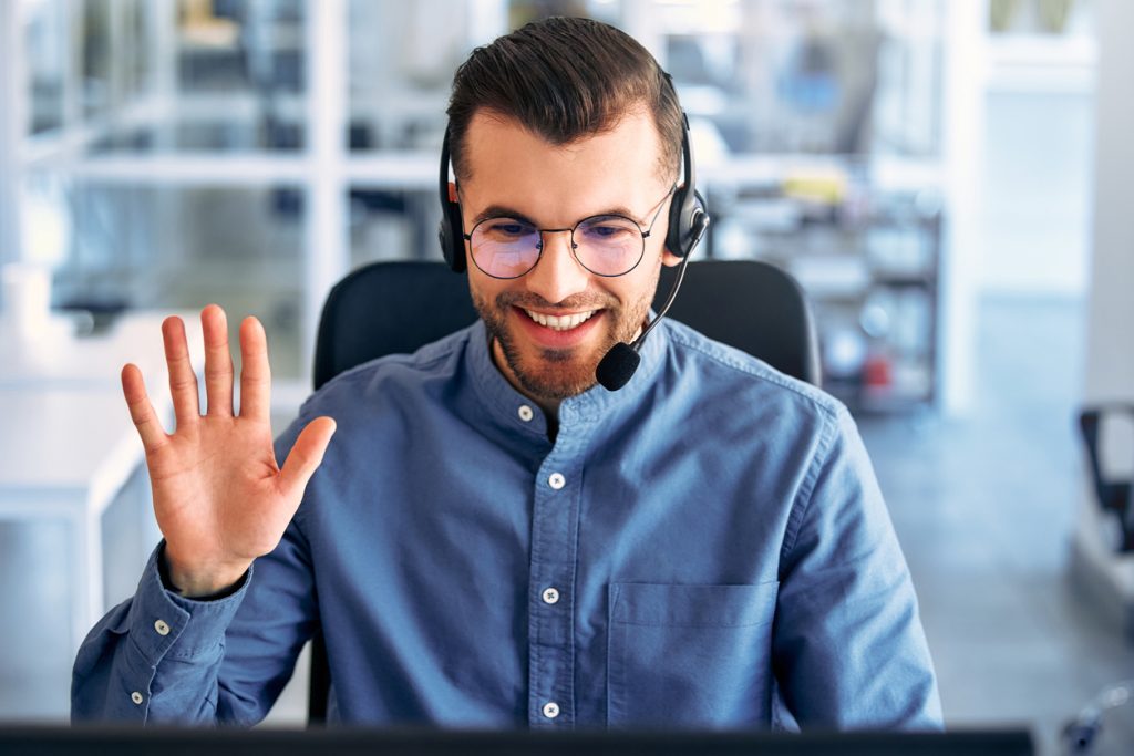 A call center worker sitting at a laptop in the office.