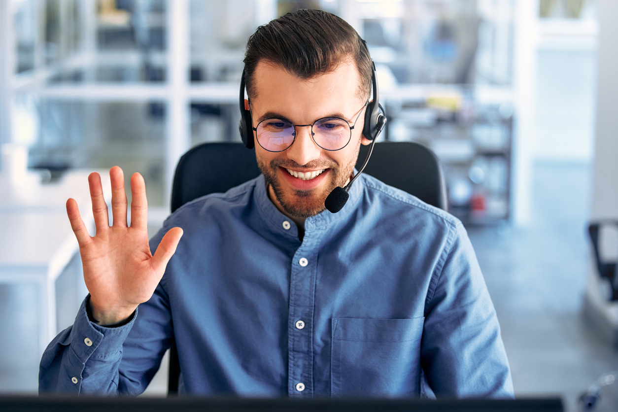 A call center worker sitting at a laptop in the office.